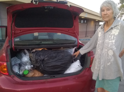 Picture of resident, Lisa, showing her car truck filled with plastic bags to dropoff