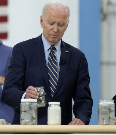 Picture of President Biden look at several type of crushed glass that City of Philadelphia use to rebuild the bridge