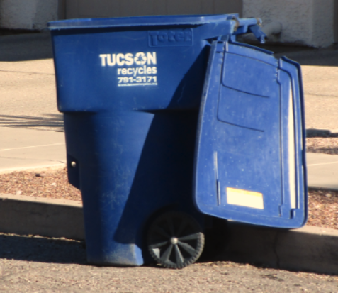 Picture of Tucson recycles bin with the lid open and placed next to the sidewalk