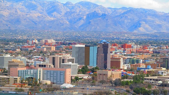 Photo of the city of Tucson with the mountains in the background.