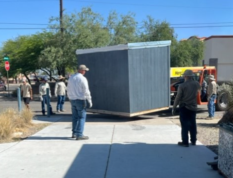 City workers work together moving the ByPad to the Ward 6 office front entry