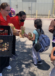 Folks from Congregation M’kor Hayim hand out some teddy bears to the kids in Casa Alitas