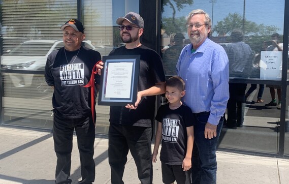 Just Churros owner and Councilmember Kevin Dahl standing outside of the establishment.