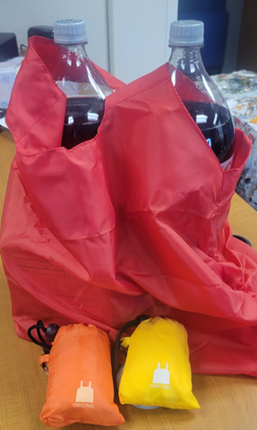 Picture shows red reusable bag is being used to carry 2 bottles of diet coke