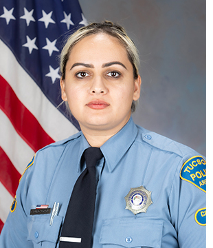 ODW CSO Rubio-Corral in uniform in front of an American flag.