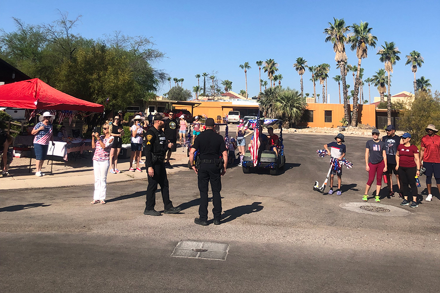 Outdoor festival shows TPD members in uniform as well as community members.