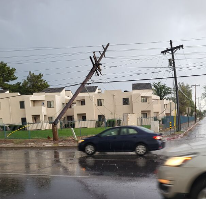 Picture shows broken pole in front of apartment complex