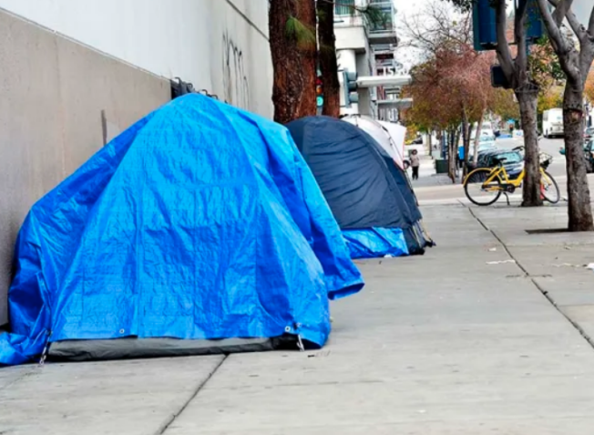 Picture shows 2 blue tents built on the side walk