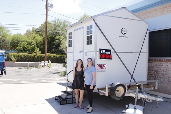 Photo of tiny shelter with office staff members Shannon Jenkins and Kate McKeever.