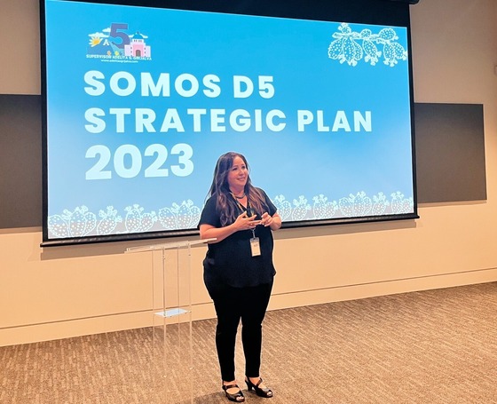 Photo of Adelita Grijalva in front of a projector screen.