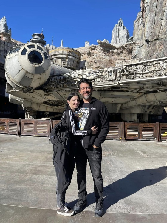 Photo of Mike and Teresita Olivares in front of the Millennium Falcon.