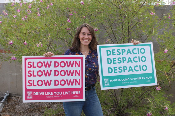 Photo of Shannon Jenkins holding the "slow down signs".