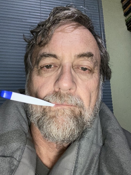 Photo of Council Member Kevin Dahl with thermometer in mouth.