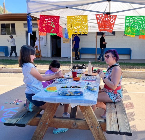 Photo of Cecile with the Amphi Neighborhood Association and a couple of kiddos making magic.