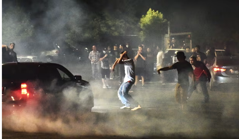 Picture shows young group gather and do the drag racing on the street
