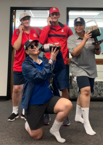 Picture of Steve with his staff-all dressed up like him in his usual work attire