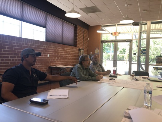 Photo of tow truck driver in meeting with Ward 3 team.