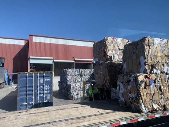 Photo of bales of cardboard, aluminum, and various recyclable materials.