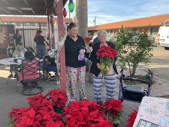 Photo of two Wildcat Inn Residents with their pointsiettas