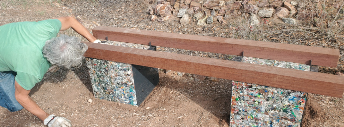 Bench set up with two beams on it in the process