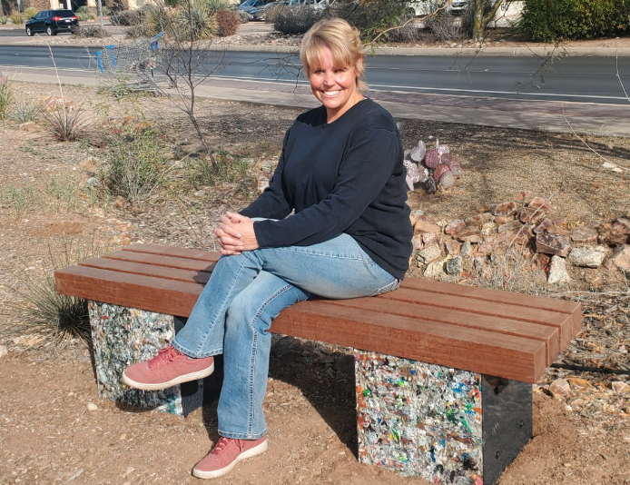 Completed bench with Shelley DeVere from El Montevideo Neighborhood sitting on their new bench after completion