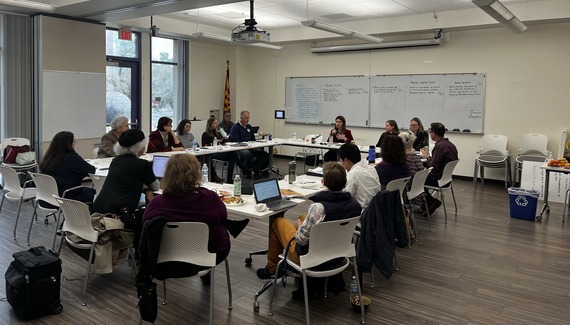 Commission on Equitable Housing & Development gathering around a table at their retreat.