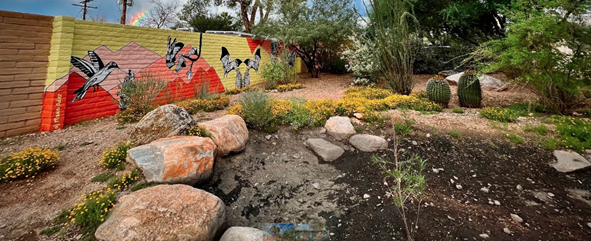 Picture of the newly painted mural next to the pollinator garden in Blenman Elm