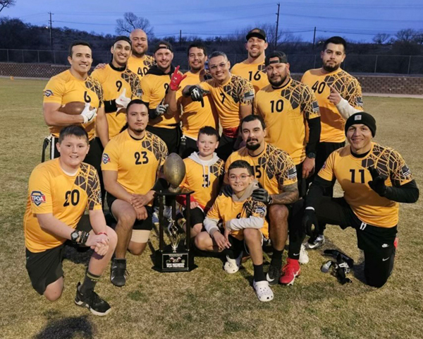 Team photo on a field, men in yellow jerseys and team uniforms.