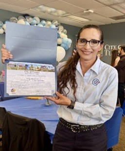 Photo of Lety Bazurto holding her certificate from Council Member Richard Fimbres