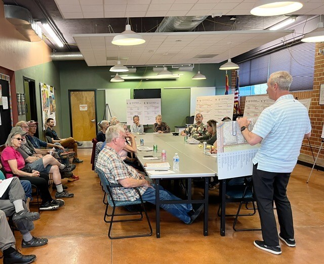 photo: Deputy Director Greg Jackson with all his poster boards!