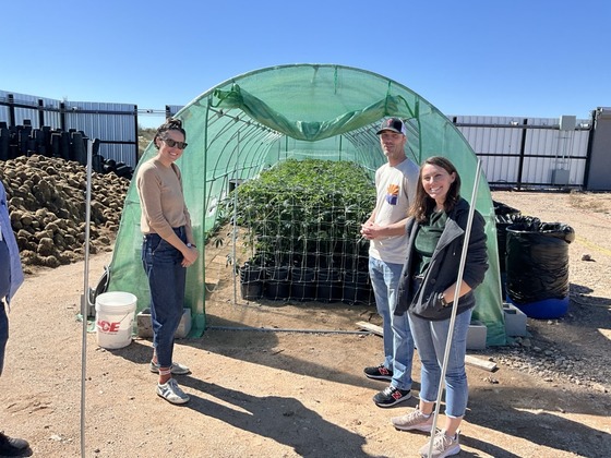 Photo of Ward 3 staff Marlene Avelino and Shannon Jenkins next to an outdoor cannabis plantation at the Prime Leaf.