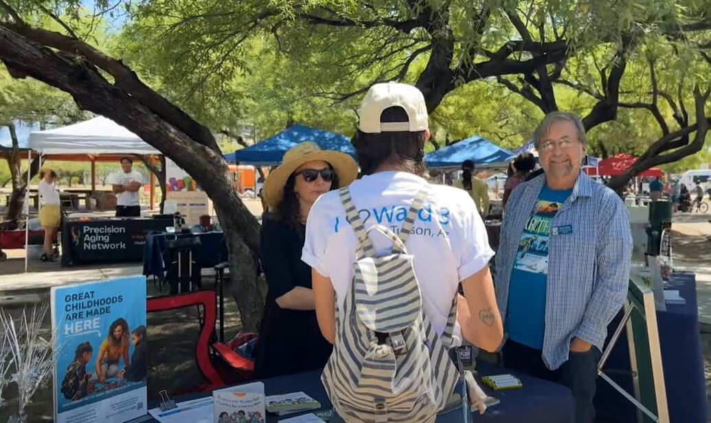 Photo of Vice Mayor Kevin Dahl at the Thrive in the 05 Spring Fair visiting with Amy with First Things First.