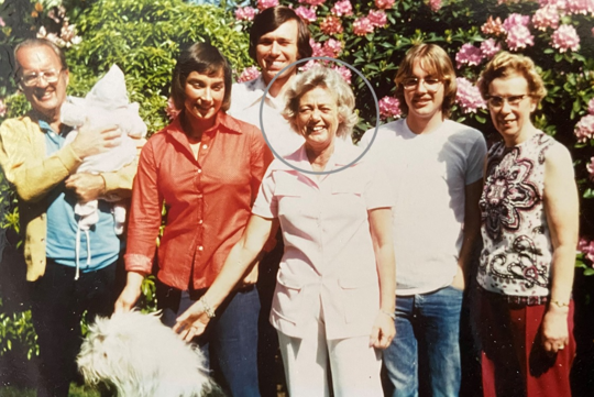 Photo of Grace Dahl in circle at family gathering.