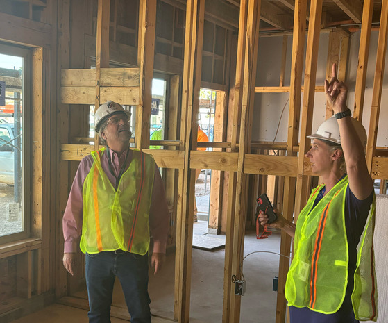 Photo: Vice Mayor Kevin Dahl and Ann Chanecka, director of Housing and Community Development inside the Milagro construction project.