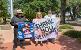 Picture of people holding thank you veterans signs