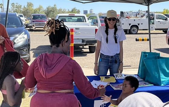 Photo of Council Aide Marlene Avelino staffing the Ward 3 table.