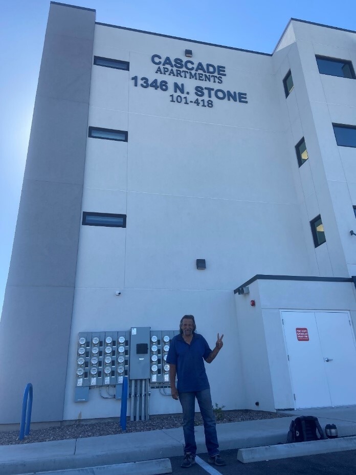 Photo of Jimmy in front of the brand new affordable senior housing in Ward 3.