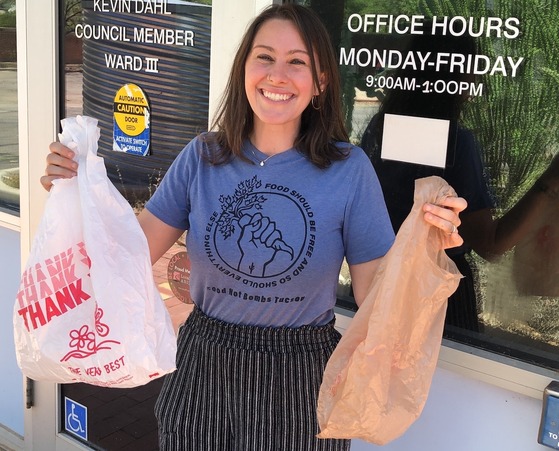 Photo of Shannon holding plastic bags.