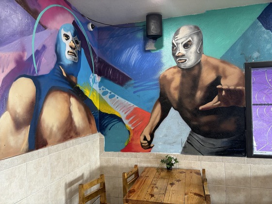 Photo of Murals of luchadores in the Juanitos dining room.