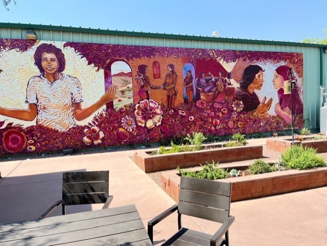 Photo of A mural and raised beds help make the courtyard an enjoyable space for guests.