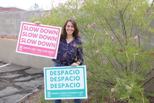 Ward # office Administrator Shannon Jenkins holding up "slow down" Ssgns