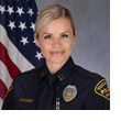 Department photo of TPD captain in uniform in front of an American flag.
