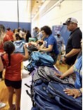 Children receiving backpacks at the event