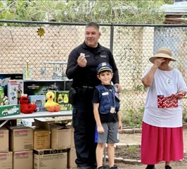 TPD officer awarding prize to camp participant