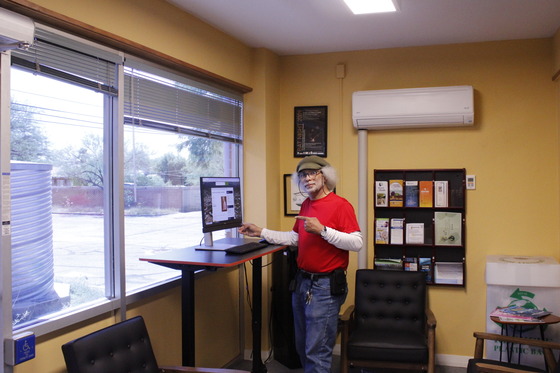 Photo of Community Liaison Mike Edmonds at the computer kiosk in our office lobby. 