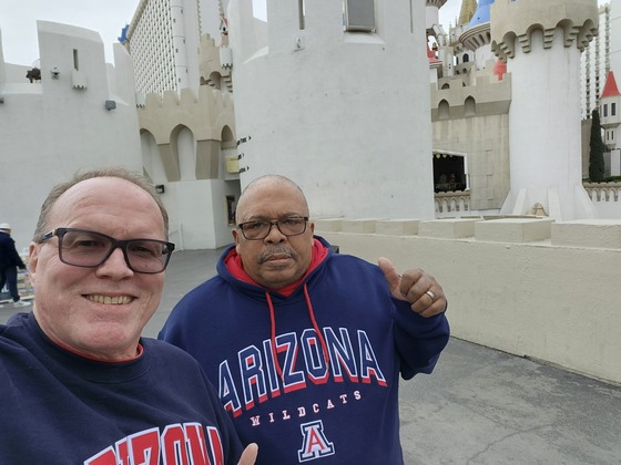 photo of Jeffrey Faircloth and his husband Roger sporting their U of A gear.