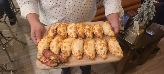 Images of empanadas and other food items from Che Cafe