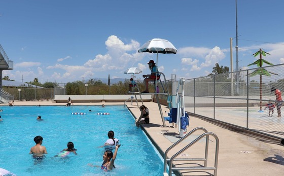 Photo of Life guard and kids at pool.