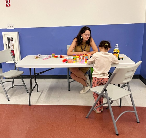 Photo: Lena With child at table.