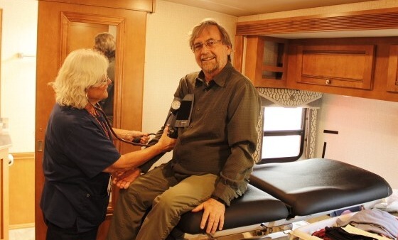  Photo of Vice Mayor Kevin Dahl get his Blood Pressure checked inside the Wellness on Wheels RV.